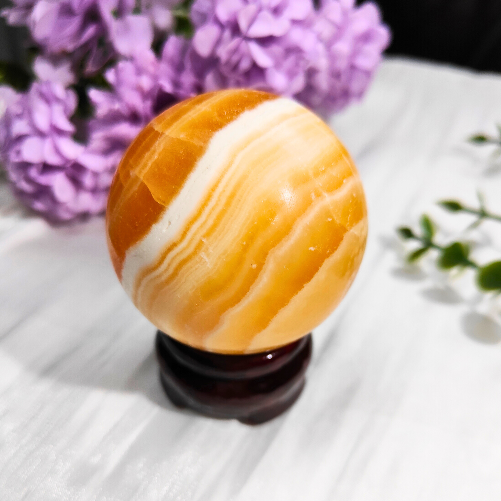 orange calcite sphere with stand